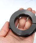 Hand holding Beefy Double Split Shaft Collar 1-3/4 In Bore, 2-3/4 In OD, 11/16 In Thick, Black Oxide Lock Collar with set screws.
