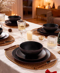 Venus 12 Piece Stoneware Plates And Bowls Set With Trim Chip Resistant Dinnerware For Four Matte Black displayed on dining table