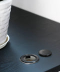 2 Inch Patio Table Umbrella Hole Ring Plug And Cap Set on black table with white planter, black 2 pack inset and cap visible
