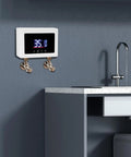 Instant Tankless Electric Water Heater Wall Mounted 3000W Kickass Heating Digital Touch Screen installed in a modern kitchen.