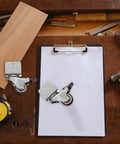 Rugged Swivel Furniture Casters With Gliding Silent Rollers And Tough Round Plates on a workbench with tools.