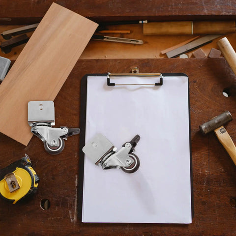 Rugged Swivel Furniture Casters With Gliding Silent Rollers And Tough Round Plates on a workbench with tools.