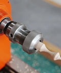 Crush Complex Turns On Your Lathe With This Badass ER32 Collet Chuck Kit featuring a lathe holding a finely detailed wood finial.