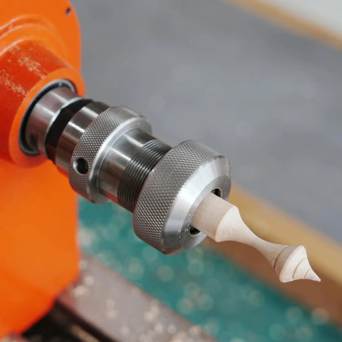 Crush Complex Turns On Your Lathe With This Badass ER32 Collet Chuck Kit featuring a lathe holding a finely detailed wood finial.