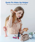 Woman using Handheld Portable Fan With 4000mAh Rechargeable Battery And 10 Hour Battery Life during makeup routine