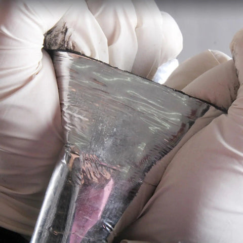 Close-up of Heavy Duty Black Asphalt Crack Repair Tape showing aluminum foil backing, ideal for sealing roofs and decks.
