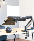 Built Tough Adjustable Laptop Desk Mount For 10 To 15.6 Inch Notebooks with heavy duty C clamp on a modern desk.