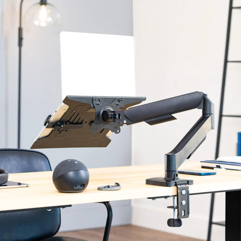 Built Tough Adjustable Laptop Desk Mount For 10 To 15.6 Inch Notebooks with heavy duty C clamp on a modern desk.