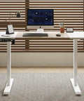 Sturdy Electric Standing Desk 55 Inch Height Adjustable Home Office Gaming Computer Table With Solid Steel Frame And Smooth Lift Motor For Epic Work Vibes, modern design with white frame and wooden top.