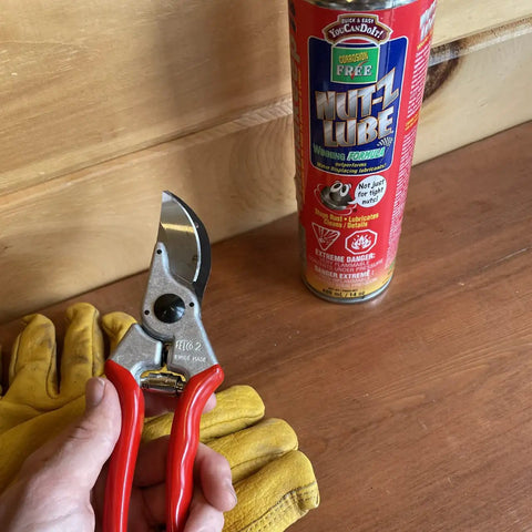 Toolbox Upgrade Odorless Penetrating Lubricant And Corrosion Inhibitor For Rusted Bolts Hinges And Locks, Multi Use Spray For Tools Electrical And Trailer Maintenance, Fast Acting Rust Busting Breaker For Automotive Farm And Marine Gear, red 400 mL can beside pruning shear