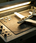 Workbench with Ten Pack Carbon Fiber Wing Spar Poles for RC Planes next to model fuselage.