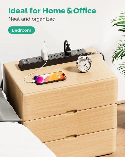 Two Pack Surge Protector Power Strips With Six Outlets And Four USB Ports on wooden dresser, devices charging, home setting.
