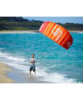 Person flying Hydra II Closed Cell Foil Water Trainer Kite 3 Meter at the beach, showcasing water relaunch and smooth power delivery.