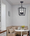 Square Metal Farmhouse Pendant Light Chandelier For Kitchen Island And Foyer hanging above dining area.