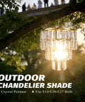 Modern Faux Chandelier Lampshade Featuring A Sleek Gold Frame And Three Tier Faceted Clear Acrylic Beads Ready To Hang For Girls Bedroom Easy Peasy Setup Next Level Bedroom Vibes, outdoor view with sunlight filtering.