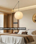 Twenty Inch Off White Japanese Rice Paper Lantern Plug In Pendant Light With Adjustable Cord Sets in a cozy bedroom setting.
