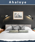 Set Of 2 Black Plug In Wall Sconces With Swing Arm And Rotatable Shade That Lets You Aim The Light over a modern bed.