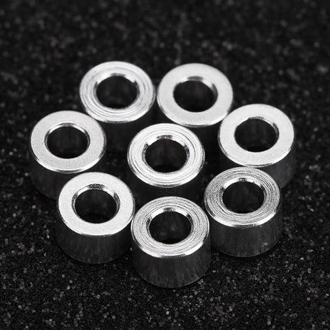 RC Car Shock Spacers Set With Eight Aluminum 6mm Upper Mount Spacers For Axial SCX10, arranged on a dark surface