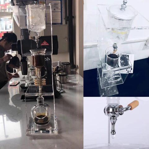 Topnotch Cold Brew Coffee Maker With Slow Drip Ice Tank And Large Capacity Glass Carafe On Solid Wood Base displayed in cafe setting.