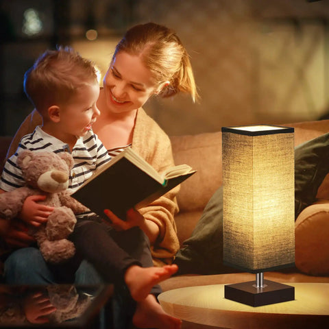 Modern Wood Table Lamp for Bedroom and Nightstand with Square Fabric Shade next to a mother reading to child on sofa