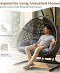 All Weather Two Person Egg Chair With Stand Cozy Oversized Wicker Hanging Loveseat Built Tough Steel Frame With Extra Thick Cushion Rain Cover Included Indoor Outdoor Patio Swing Chair Dark Grey with a person sitting on it
