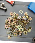 Heavy Duty Golden U Nut Fasteners For Truck And Rig 50 Pack Badass Vibration Proof Chimney Clips And Engine Undertray Hardware That Secures License Plates Without Any Hassle Daily in a pile on a workbench.