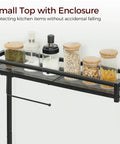 Small top with enclosure on Rustic Brown And Black Bakers Rack With Storage And Microwave Stand, holding jars and spices.