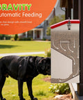 Heavy Duty Automatic Dog Feeder For Large Dogs With 25lb Gravity Bowl Clear Window View and Easy Push Gate Design For Big Hounds and Hustling Pet Parents Daily with dog eating from it.
