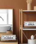 Smooth Flipping Open Closed Sign, Handmade Metal Counter Decor For Your Cozy Home Bar Or Office Coffee Spot With Black Stand And Embossed Lettering Straight Up Real Deal displayed on shelf.