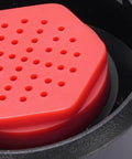 Close-up of Industrial Grade Faucet Mounted Eyewash Spray Head Replacement with red ABS construction and perforated surface.