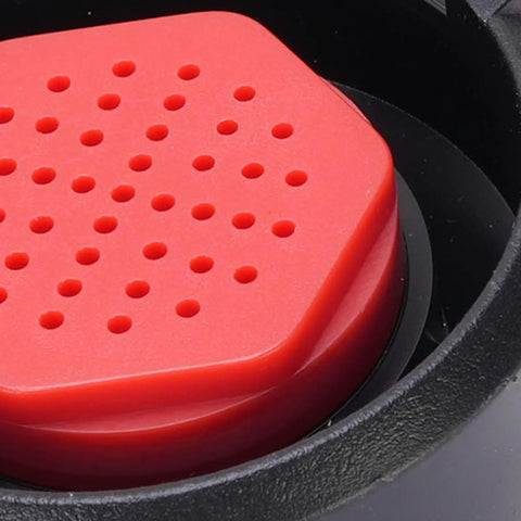Close-up of Industrial Grade Faucet Mounted Eyewash Spray Head Replacement with red ABS construction and perforated surface.
