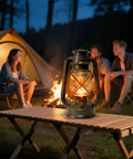 Vintage LED Outdoor Lantern With Dancing Flame Wick on camping table next to tent and campfire, Bronze Color, Weatherproof