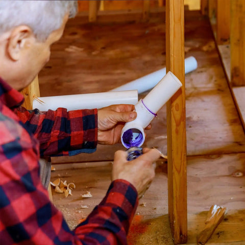 Person installing Two Pack White 25mm Conduit Pipes 1 Meter Long for DIY Electrical Wiring in wooden framework