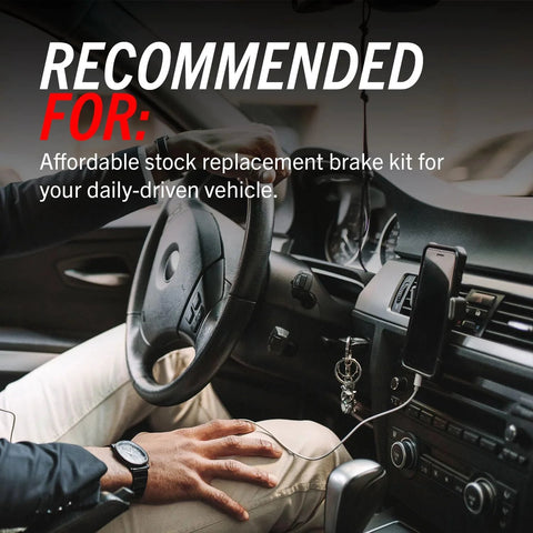 Front interior view of a car showing steering wheel, gear shift, ignition keys, and mounted phone.