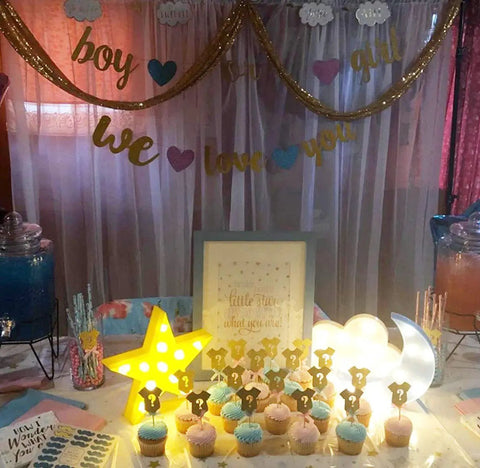 Three Piece 3D Moon Cloud Star LED Night Light Set for Kids and Adults at a gender reveal party with cupcakes