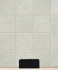 Heavy Duty Black Stainless Steel Tile Display Hangers mounted on a textured light-colored tile surface.