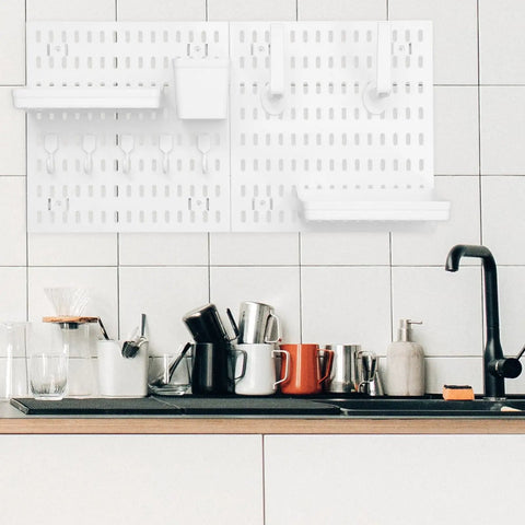 Medium Size Nail Free Wall Pegboard Organizer With Heavy Duty Hooks And Solid Wood Panel shown above a cluttered kitchen counter.