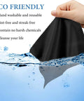 Black microfiber glasses cleaning cloth held by hand over water splash front view