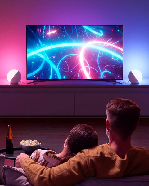 Touch Lamp Multicolor Night Light For Kids illuminating soft ambient lighting while a couple watches TV.