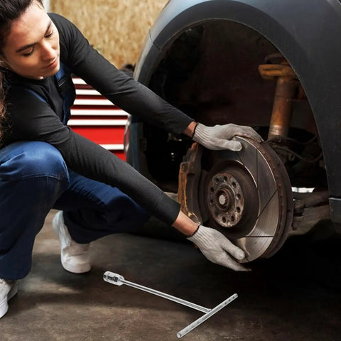 Person using a T Handle Socket Wrench Set with Serious Grip for Lug Nuts and Auto Repairs on a vehicle wheel.