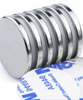Heavy Duty Neodymium Disc Magnets 6 Pack With Double Sided Adhesive Backing showing smooth silver discs stacked with adhesive pads.