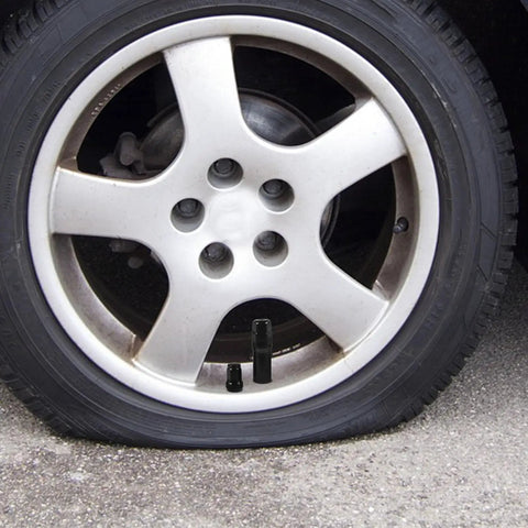 Heavy Duty 21 Piece Steel Wheel Lug Nuts With Anti Theft Hex Design on silver alloy wheel with flat tire.