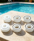 Roller Bearing Guide Kit RCX26000 RCX26001 For TigerShark Robotic Pool Cleaner DIY Friendly Pro Grade Replacement Kit Includes One RCX26001 Bearing And Two RCX26000 Bearings For Smooth Wheel Rotation And Stable Tracking, six white bearings on pool deck