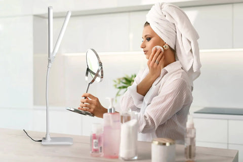 Double Head Desk Lamp With Independent Switch next to woman applying makeup with sleek white design in modern bathroom.