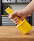 Hand holding yellow plastic Two Pack Handheld Pallet Wrap Dispenser Handles With Comfortable Grip For Stretch Film Roll Holder, Effortless Wrapping For Shipping, Warehouse And Moving Supplies