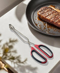Stainless Steel Scissor Tongs Set With 10 Inch And 12 Inch Tongs, 2 Piece Kitchen Tool For Pro Grade Cooking, Grilling, Food Prep, And Serving, Heavy Duty 304 Stainless Steel, Dishwasher Safe, Rust Resistant, scissor tongs beside a steak pan