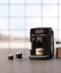 Crisp Roast Fully Automatic Espresso Maker With Killer LatteGo Milk Frothing, sleek black design and brewed coffee cups displayed.