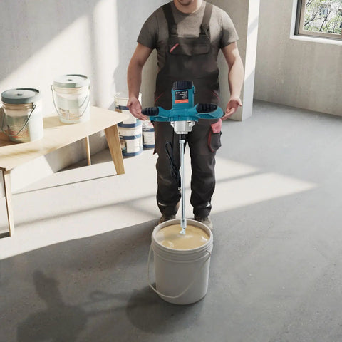 Worker using the Beefy 2100W Electric Cement Mixer Handheld Portable Concrete And Mortar Mixer, mixing paint in workshop.