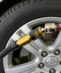 Five In One Universal Quick Connect Air Coupler For Industrial Air Compressors One Quarter Inch NPT Fittings in use on car tire
