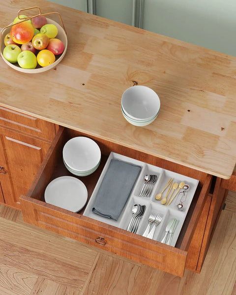 Drawer open on drop leaf kitchen island on wheels with two drawers and double door cabinets, brown finish, showing utensils